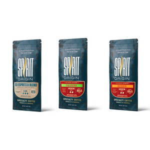 Three packages of Spirit coffee on a white background